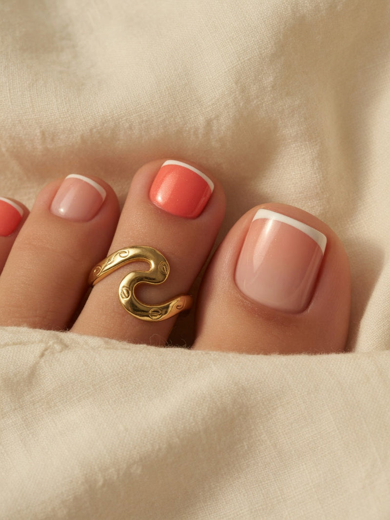 Coral pedicure paired with gold wave toe ring, color guide editorial